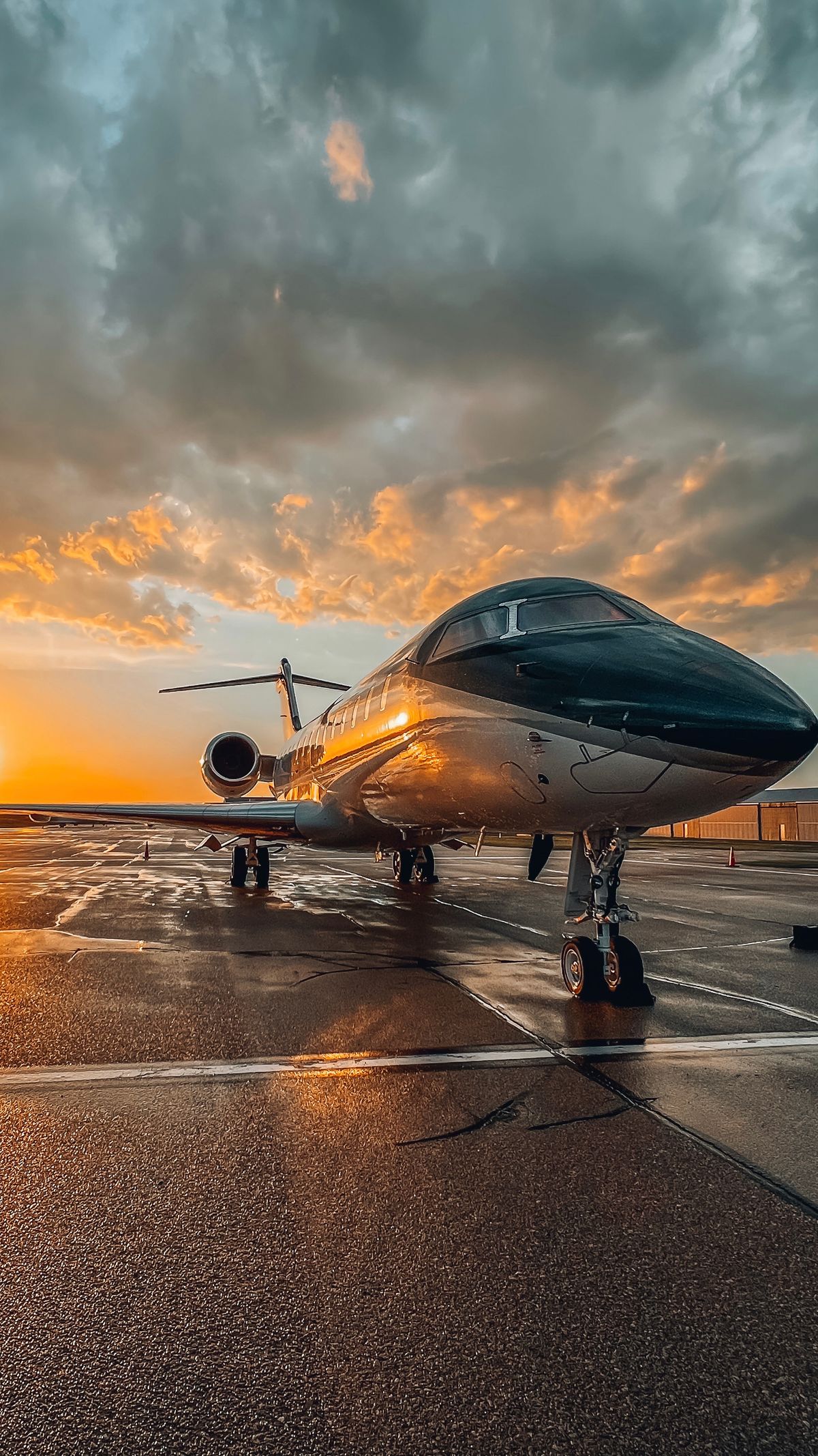 A sleek private jet on the apron at sunset